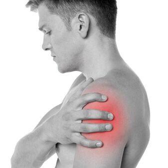 Person holding a painful shoulder